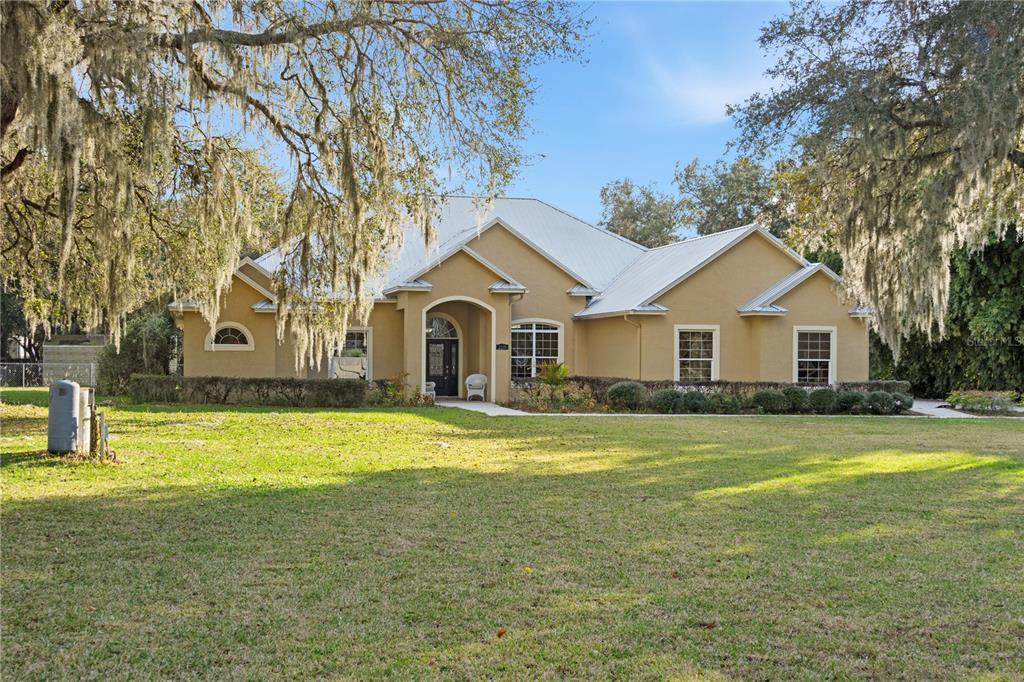 3108 Carter Jones Road Groveland, FL 34736 - Photo 2 of 54 a front view of a house with a yard and swimming pool
