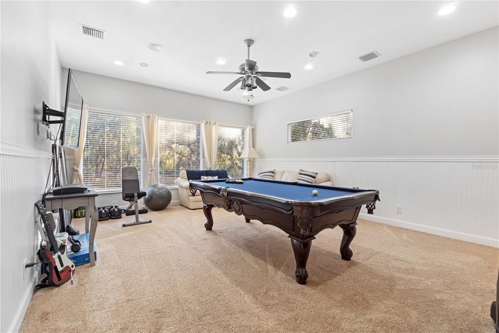 3108 Carter Jones Road Groveland, FL 34736 - Photo 21 of 54 a living room with furniture pool table and a window