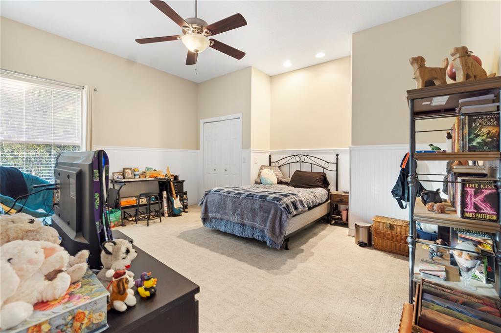 3108 Carter Jones Road Groveland, FL 34736 - Photo 27 of 54 a bedroom with furniture and a bed