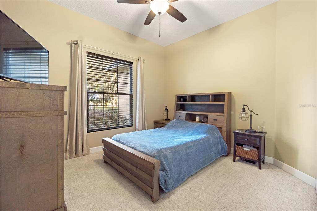 3108 Carter Jones Road Groveland, FL 34736 - Photo 30 of 54 a bedroom with a bed and a table