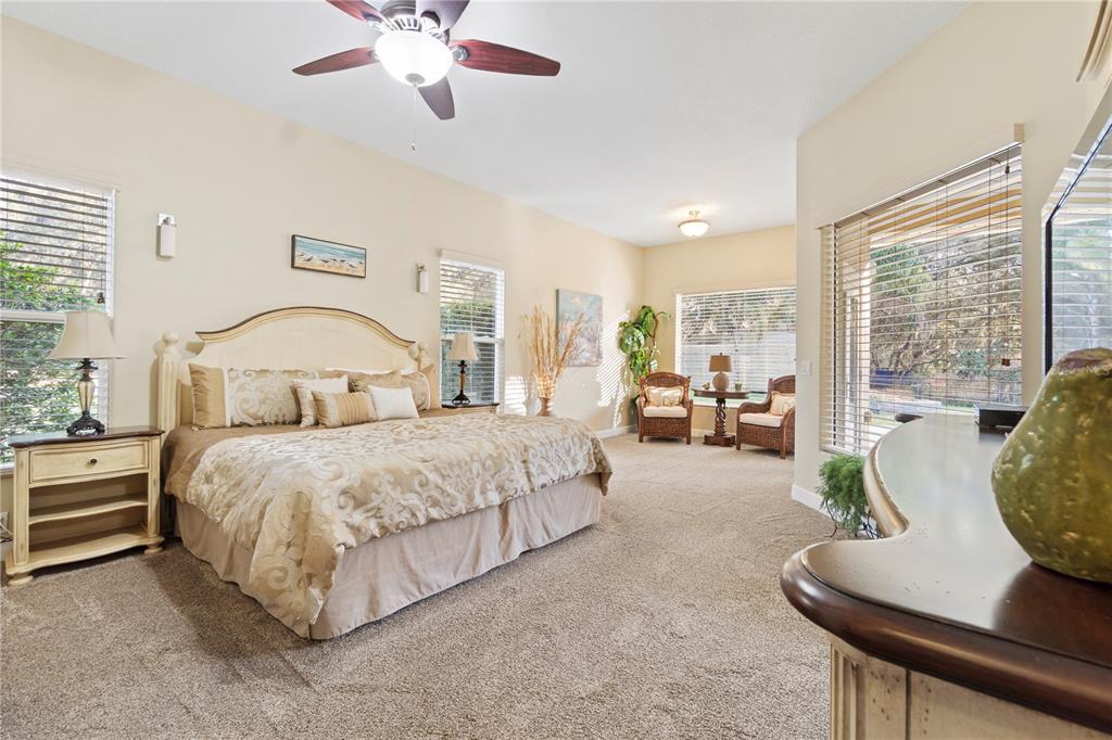 3108 Carter Jones Road Groveland, FL 34736 - Photo 32 of 54 a bedroom with a large bed and a chandelier