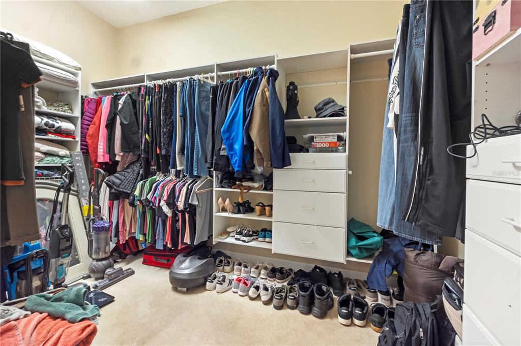 3108 Carter Jones Road Groveland, FL 34736 - Photo 36 of 54 a view of walk in closet with clothes and shoes