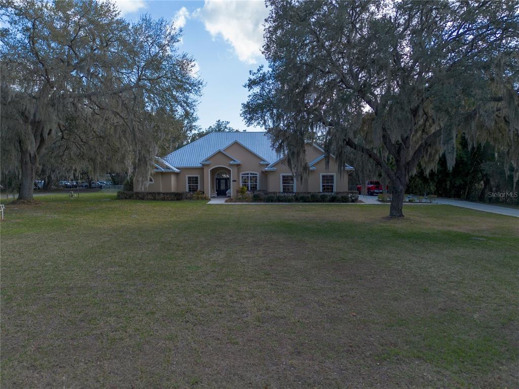 3108 Carter Jones Road Groveland, FL 34736 - Photo 45 of 54 a front view of a house with garden