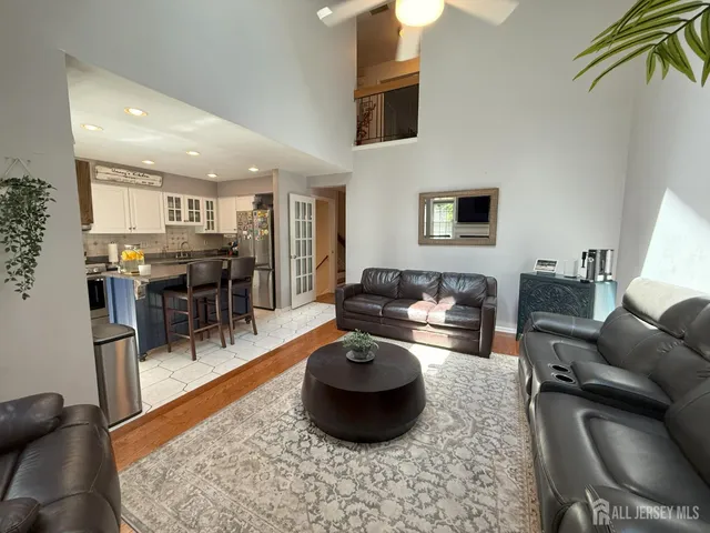 a living room with furniture a rug and a table