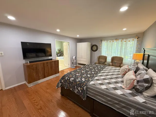 a bedroom with bed and a flat screen tv