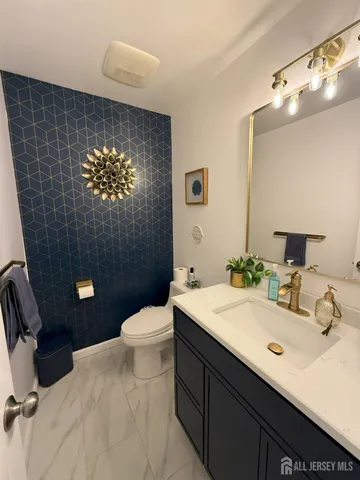 a bathroom with a sink a toilet and mirror