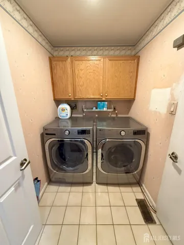 a utility room with sink dryer and washer