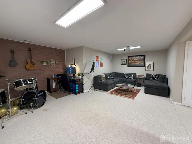 a view of a livingroom with furniture and a large window