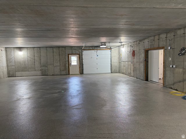 1325 South Round Road East Laketown, UT 84038 - Photo 36 of 40 Spacious garage with an epoxy-coated concrete floor, pre-cast concrete walls, and overhead lighting