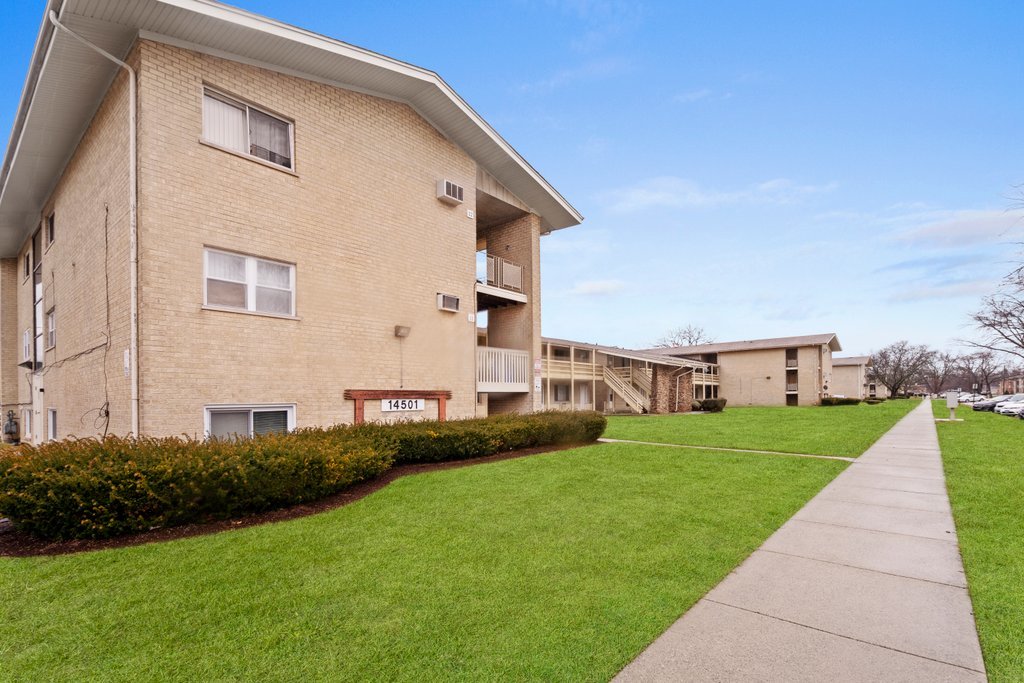 14501 Keystone Avenue, Unit 12 Midlothian, IL 60445 - Photo 2 of 11 a view of a house with a yard