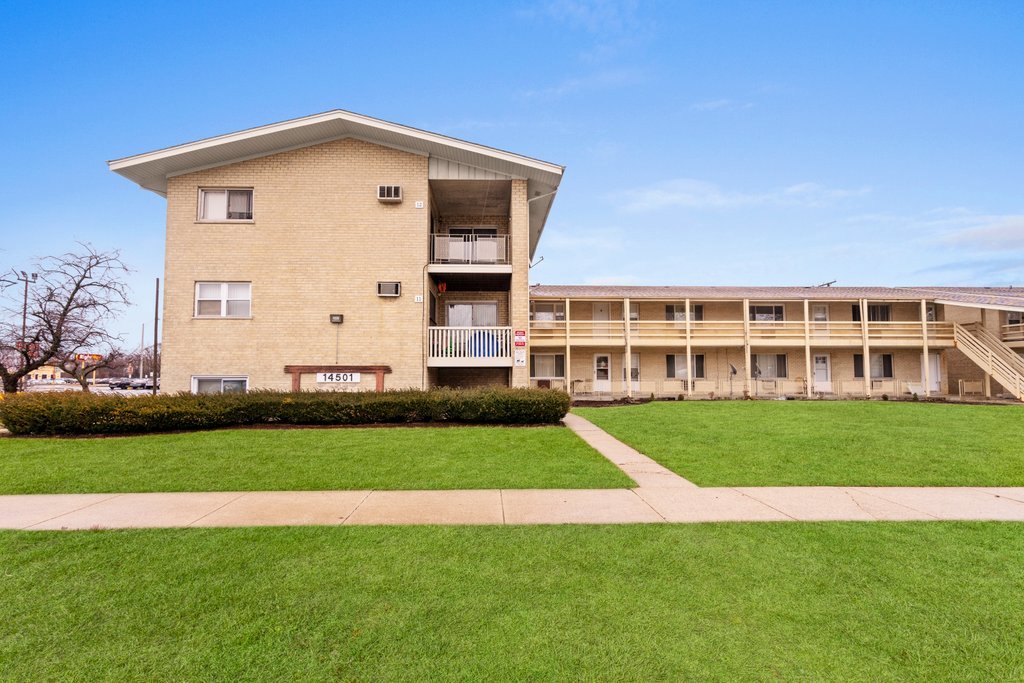 14501 Keystone Avenue, Unit 12 Midlothian, IL 60445 - Photo 3 of 11 a front view of a house with a yard