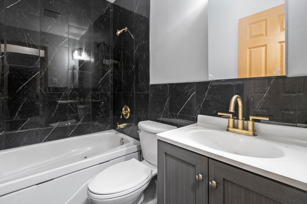 14501 Keystone Avenue, Unit 12 Midlothian, IL 60445 - Photo 9 of 11 a bathroom with a sink a toilet and bathtub