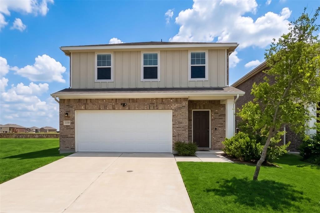 2119 Hamilton Street Princeton, TX 75407 - Photo 2 of 32 Contemporary two-story residence featuring a two-car garage, brick facade on the first level, board and batten siding on the second level, a concrete driveway, and a welcoming front entrance