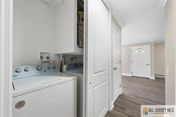 a view of washer and dryer with wooden floor