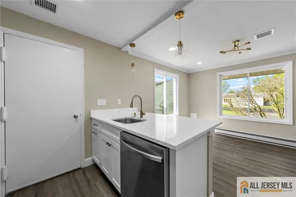 a view of a bathroom with a sink and wooden floor