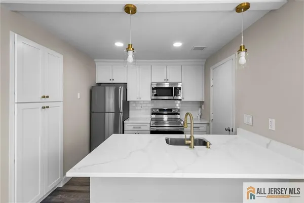 a kitchen with stainless steel appliances a refrigerator sink and stove