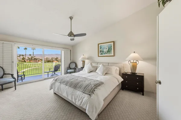 a bedroom with a bed and a large mirror
