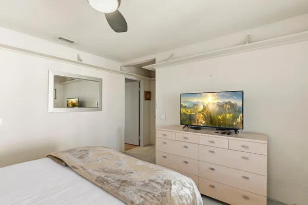 a view of a patio with table and chairs with wooden floor and fence