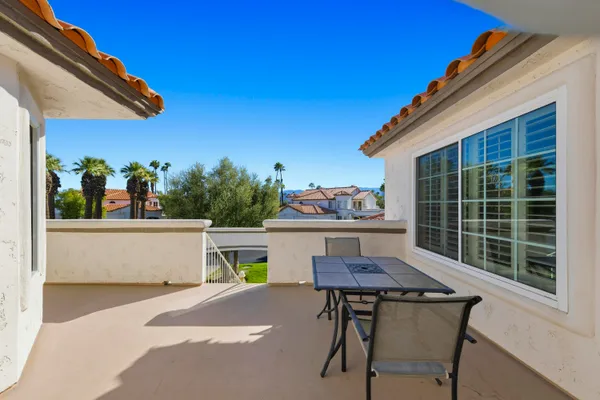 a view of a balcony with chairs