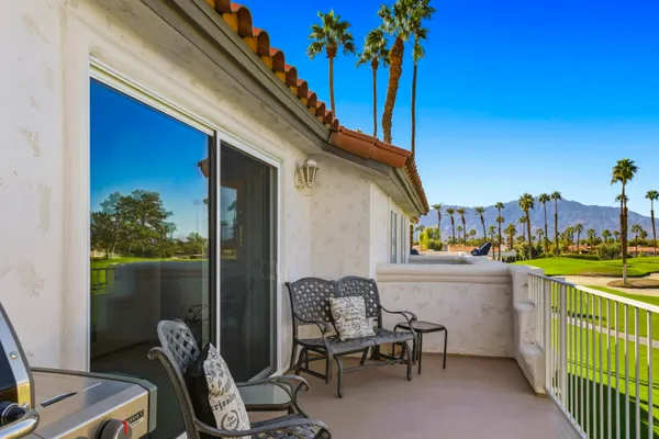 a view of a patio with a table and chairs