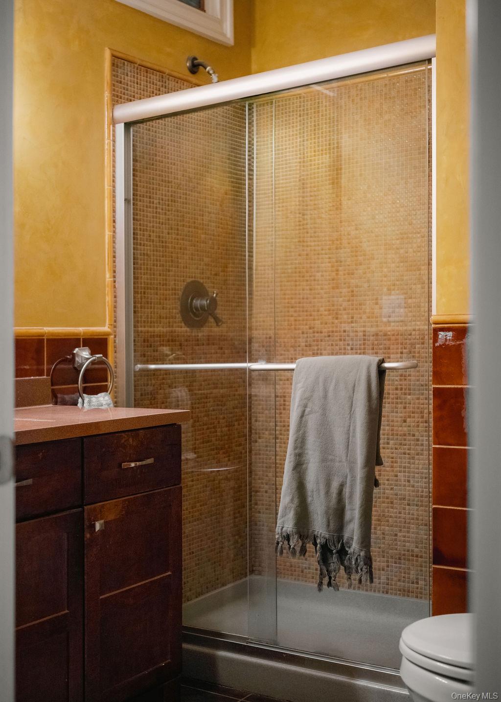 92 Fiddlers Bridge Road Staatsburg, NY 12580 - Photo 13 of 32 Enclosed shower with sliding glass doors, mosaic tile surround, and a chrome shower fixture
