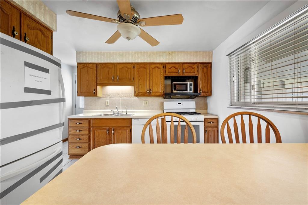 257 Robinhood Road Pittsburgh, PA 15220 - Photo 12 of 35 a kitchen with sink cabinets and window