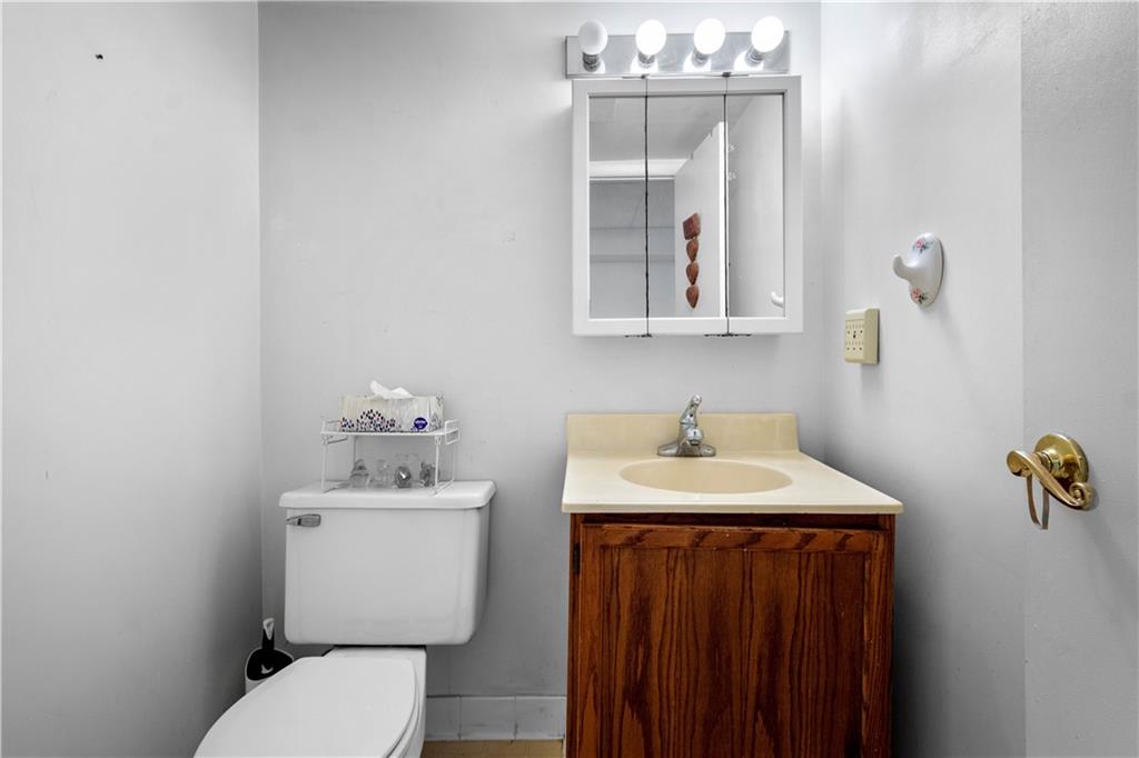 257 Robinhood Road Pittsburgh, PA 15220 - Photo 23 of 35 a bathroom with a sink a toilet and mirror