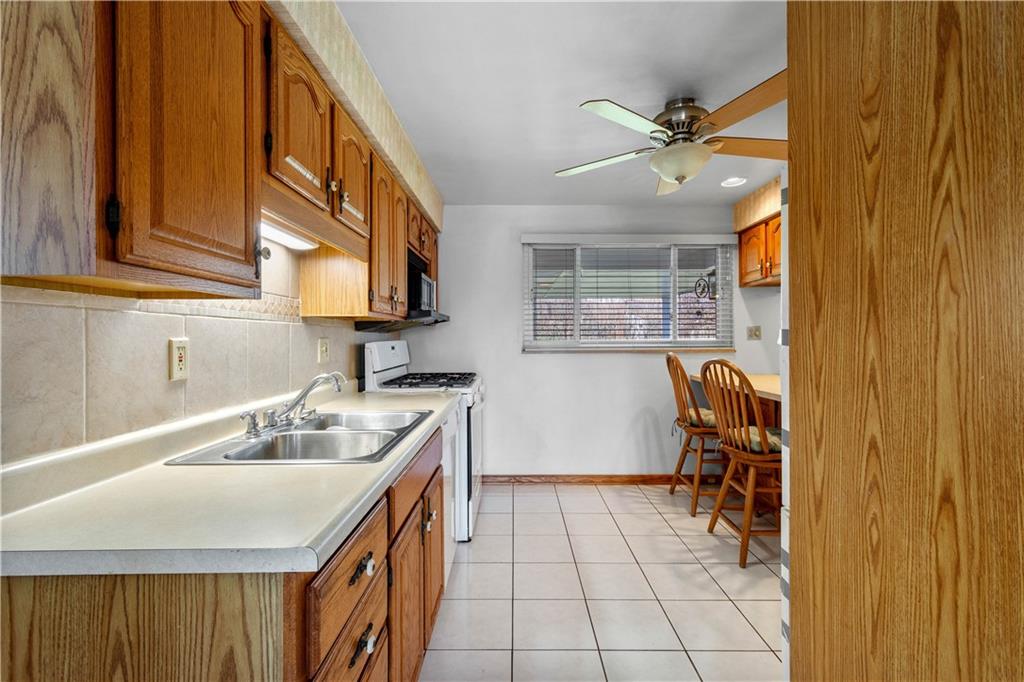 257 Robinhood Road Pittsburgh, PA 15220 - Photo 9 of 35 a kitchen with a sink cabinets and appliances