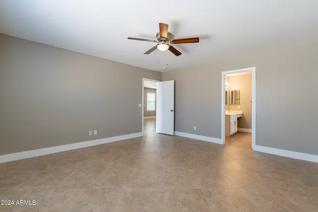 a view of an empty room with a ceiling fan