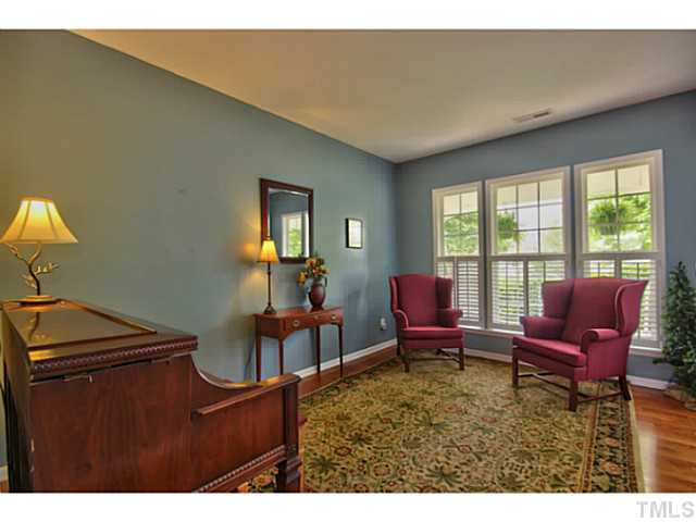 7620 Derek Drive Raleigh, NC 27613 - Photo 5 of 25 To the right is the formal living room. It has Hardwoods and great windows for natural light. This is a nice place to cozy up with a book. Living Room