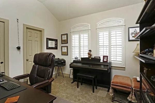 a bedroom with a bed table and window