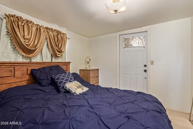 a large bed sitting in a bedroom next to a cabinet