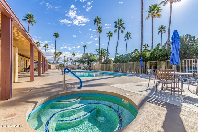 a swimming pool with outdoor seating and yard