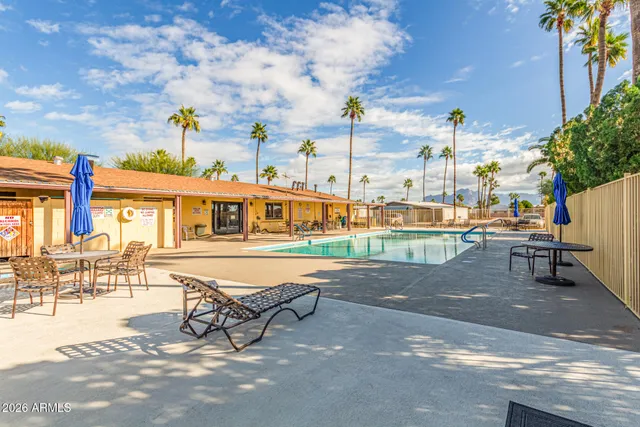 a row of palm trees in front of a building