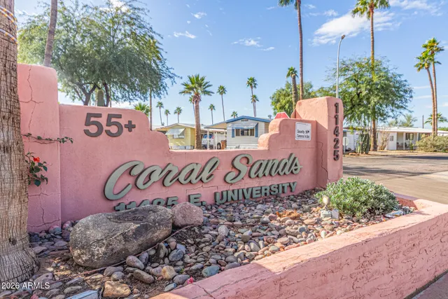 a view of a patio with table and chairs potted plants and a large tree