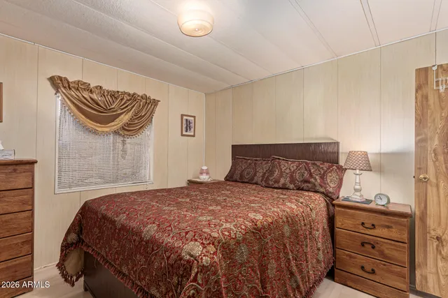 a bedroom with a bed and two night stand