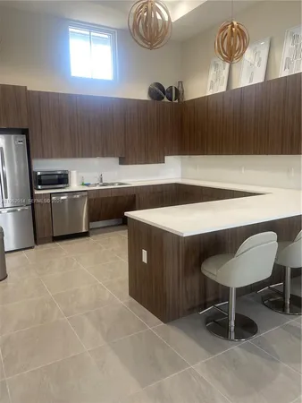 a kitchen with cabinets and chairs