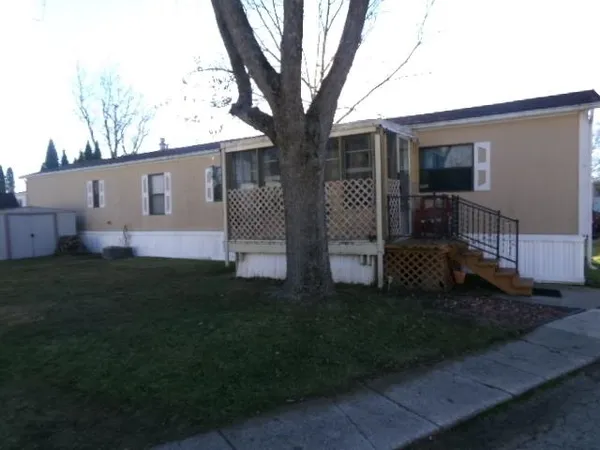 a front view of house with yard and green space