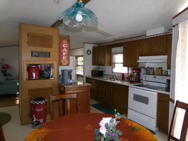 a kitchen with stainless steel appliances granite countertop a stove refrigerator and cabinets
