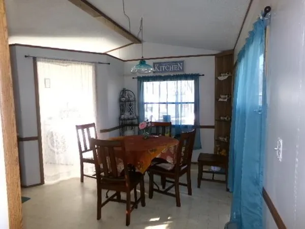 a view of a dining room with furniture and window