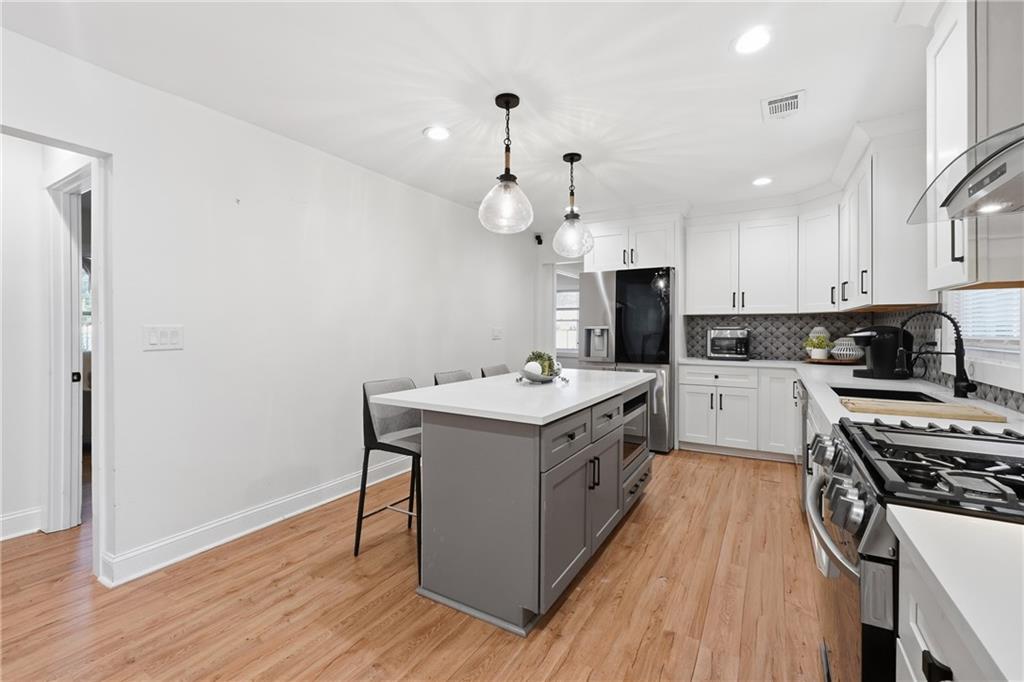 1973 Glendale Drive Decatur, GA 30032 - Photo 12 of 28 a kitchen with a stove sink and cabinets