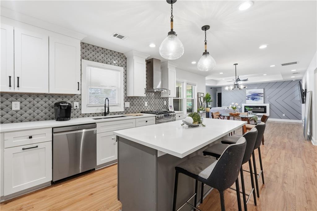 1973 Glendale Drive Decatur, GA 30032 - Photo 14 of 28 a kitchen with a dining table chairs stainless steel appliances and cabinets