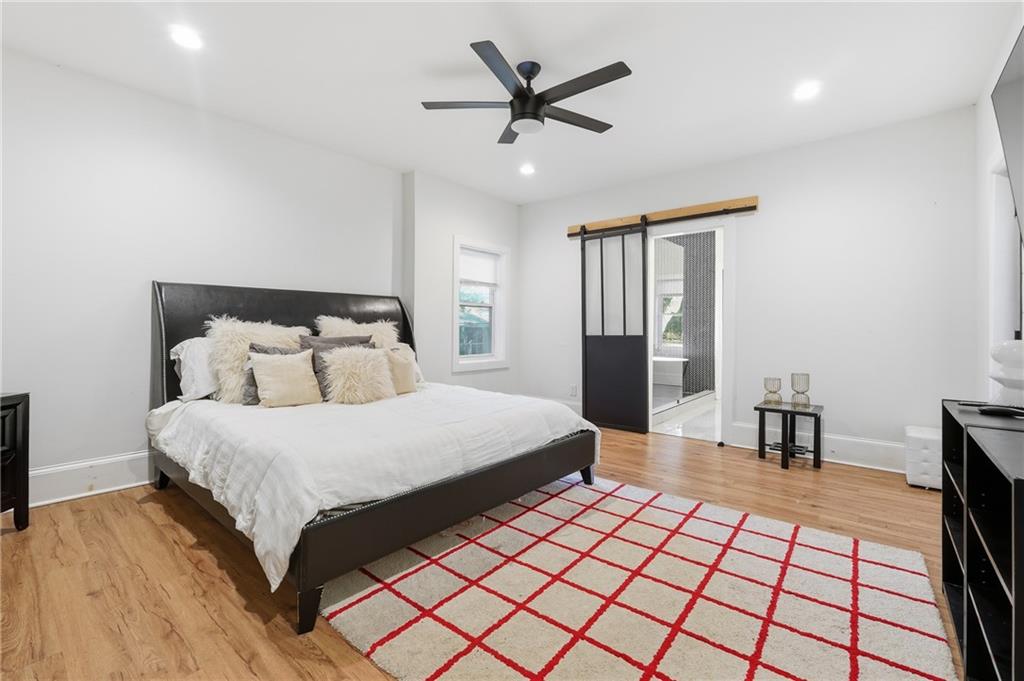 1973 Glendale Drive Decatur, GA 30032 - Photo 15 of 28 a bedroom with a large bed and a chandelier