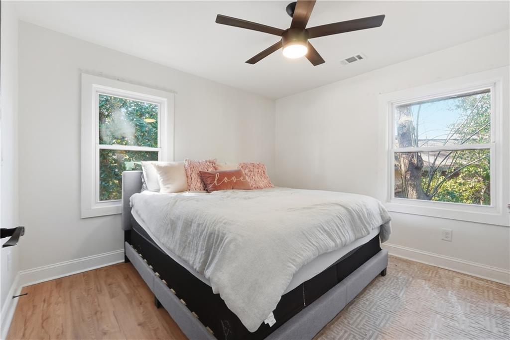 1973 Glendale Drive Decatur, GA 30032 - Photo 25 of 28 a large bed sitting in a bedroom next to a window