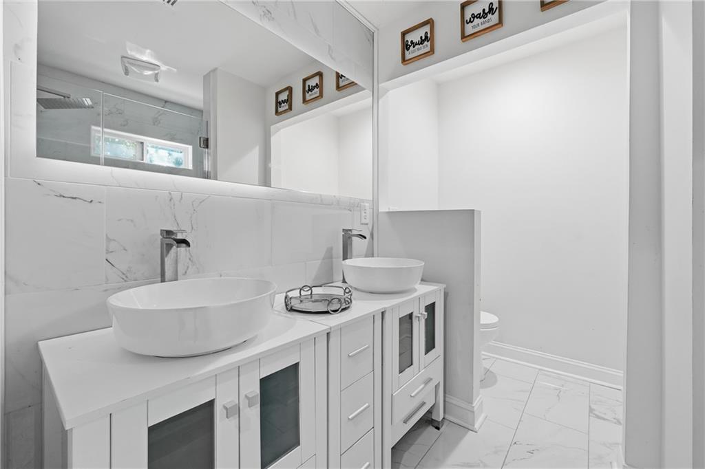 1973 Glendale Drive Decatur, GA 30032 - Photo 26 of 28 a bathroom with a sink and a mirror