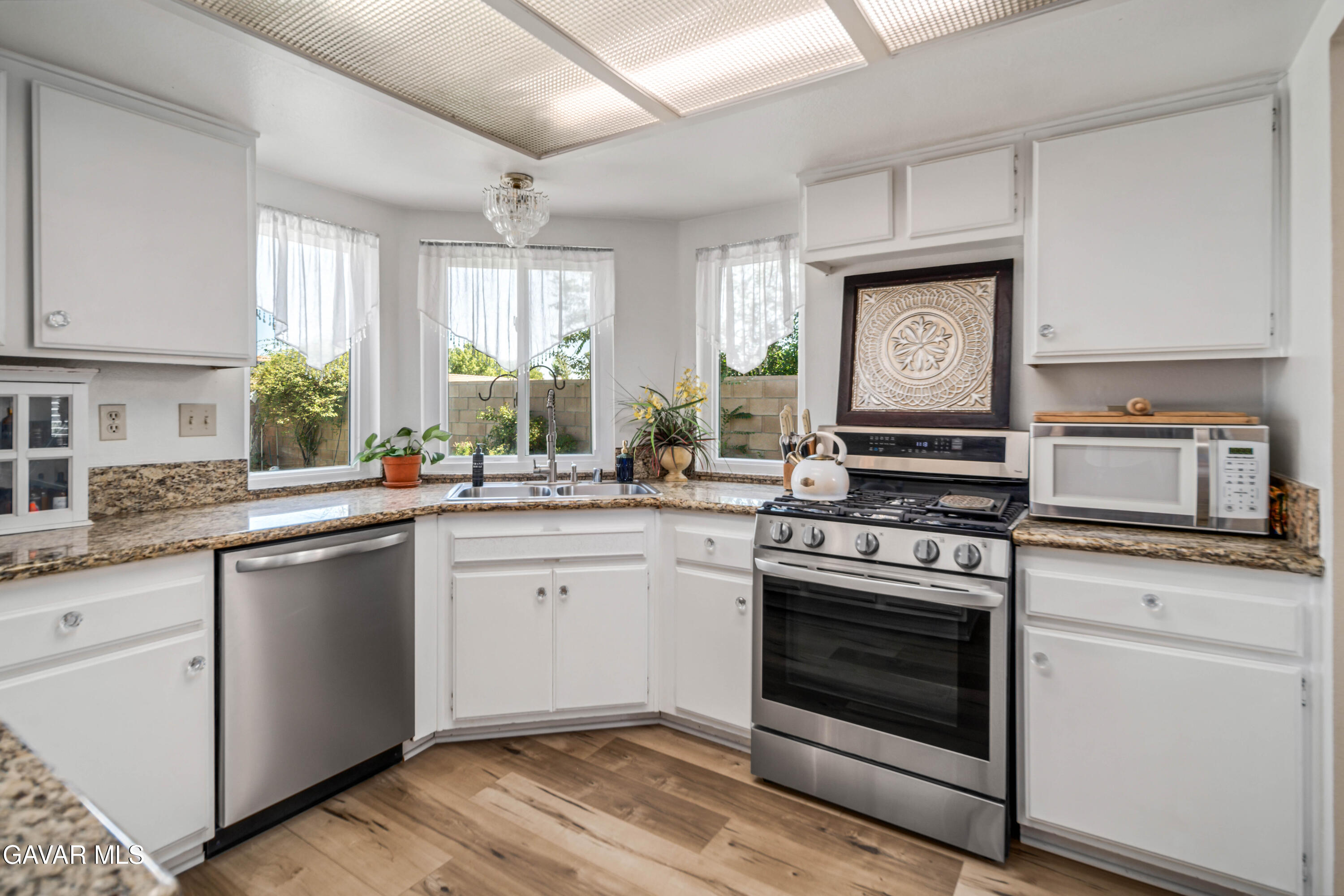 4535 Talento Way Palmdale, CA 93551 - Photo 11 of 43 a kitchen with white cabinets appliances and a window