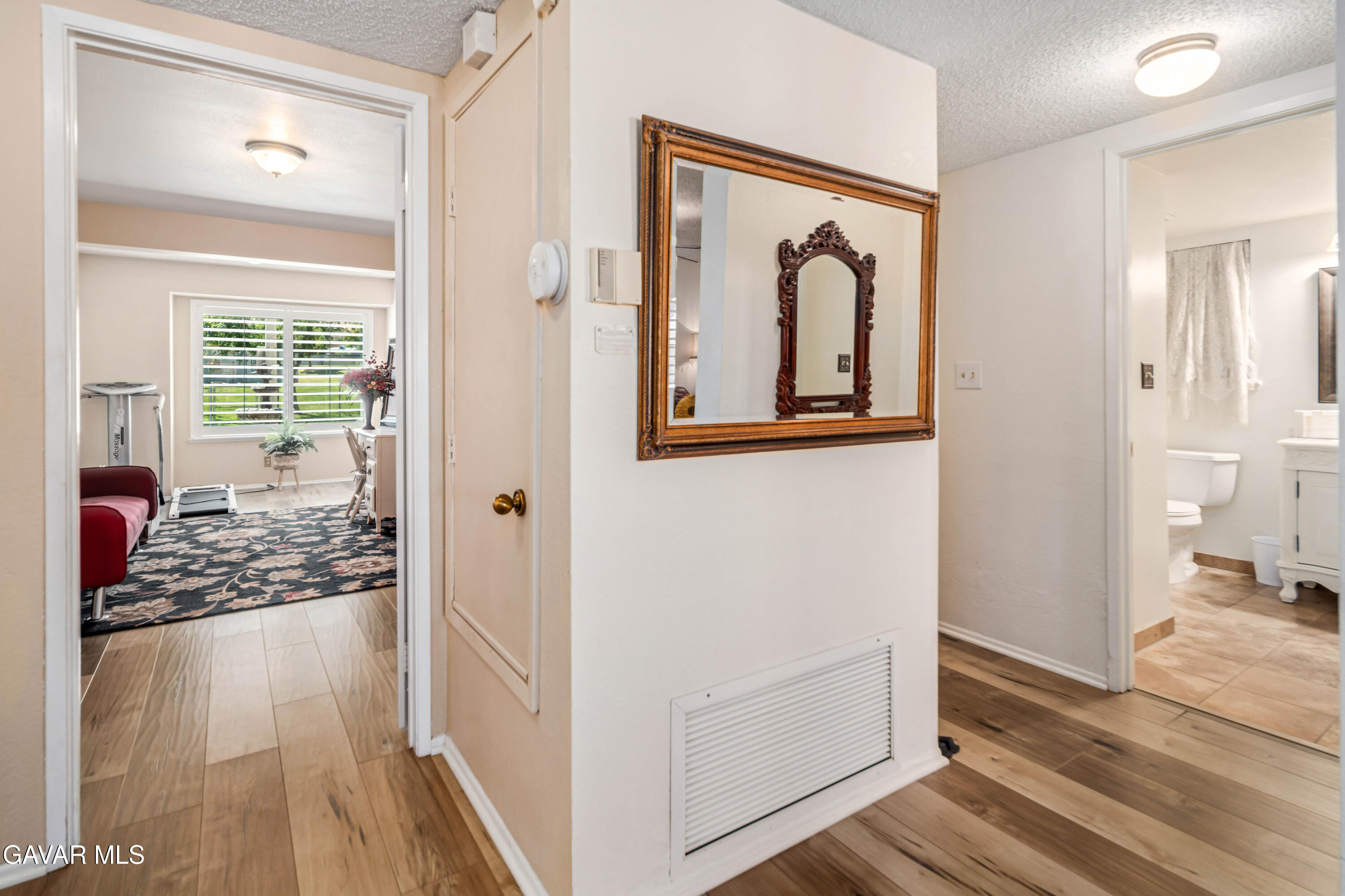 4535 Talento Way Palmdale, CA 93551 - Photo 16 of 43 a view of a hallway with wooden floor and windows
