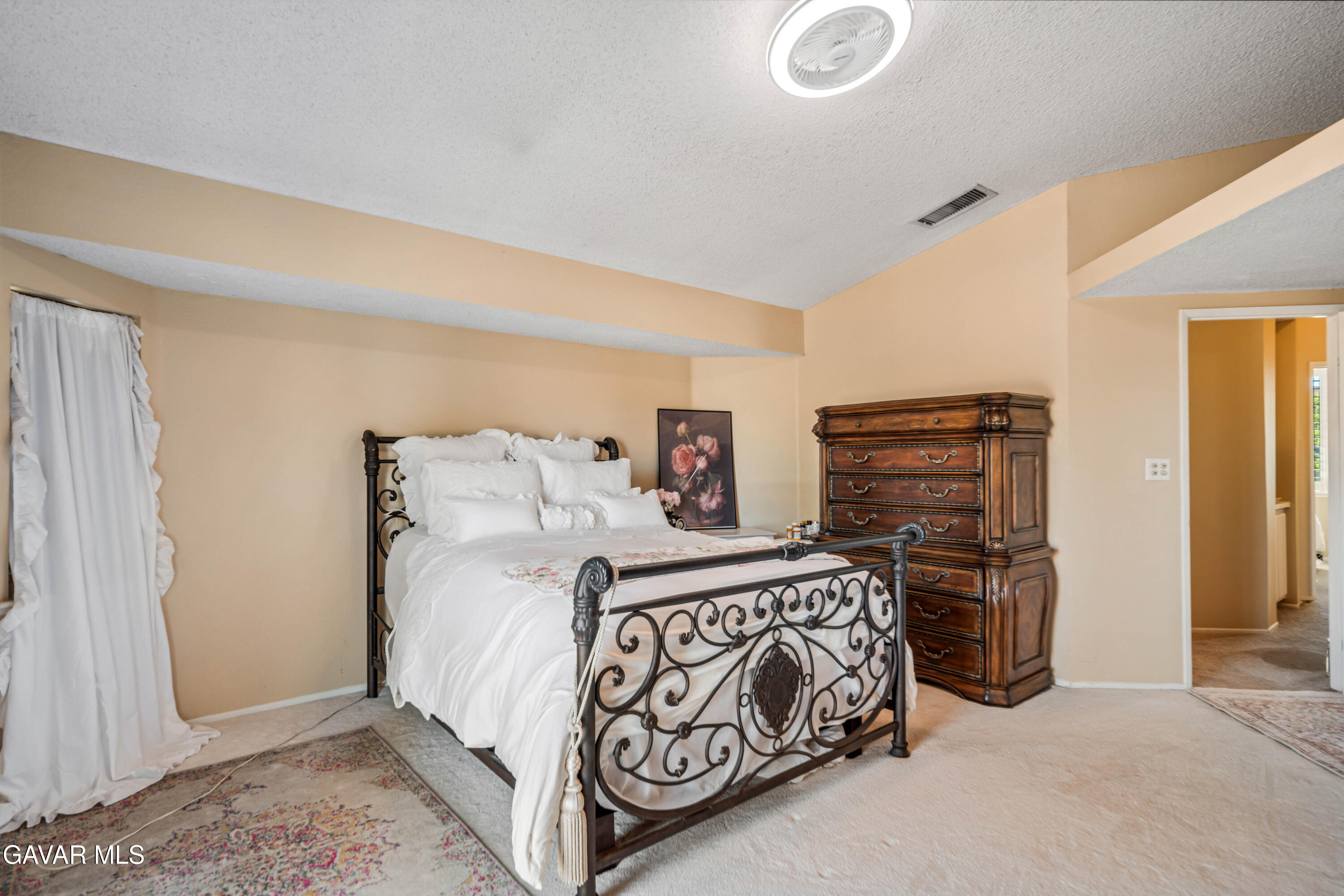 4535 Talento Way Palmdale, CA 93551 - Photo 23 of 43 a bedroom with a bed and a refrigerator