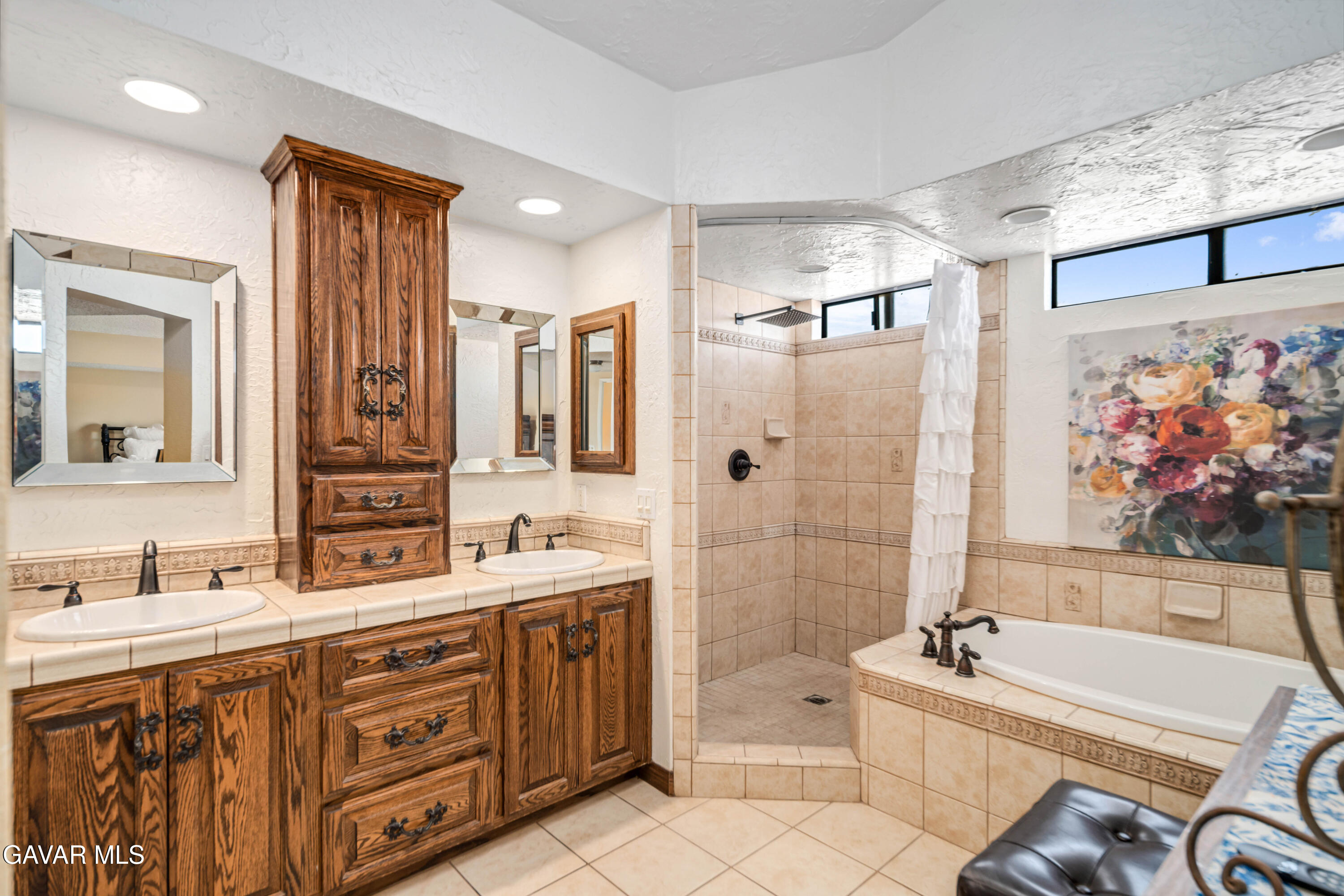 4535 Talento Way Palmdale, CA 93551 - Photo 25 of 43 a bathroom with a double vanity sink large mirror and a bathtub