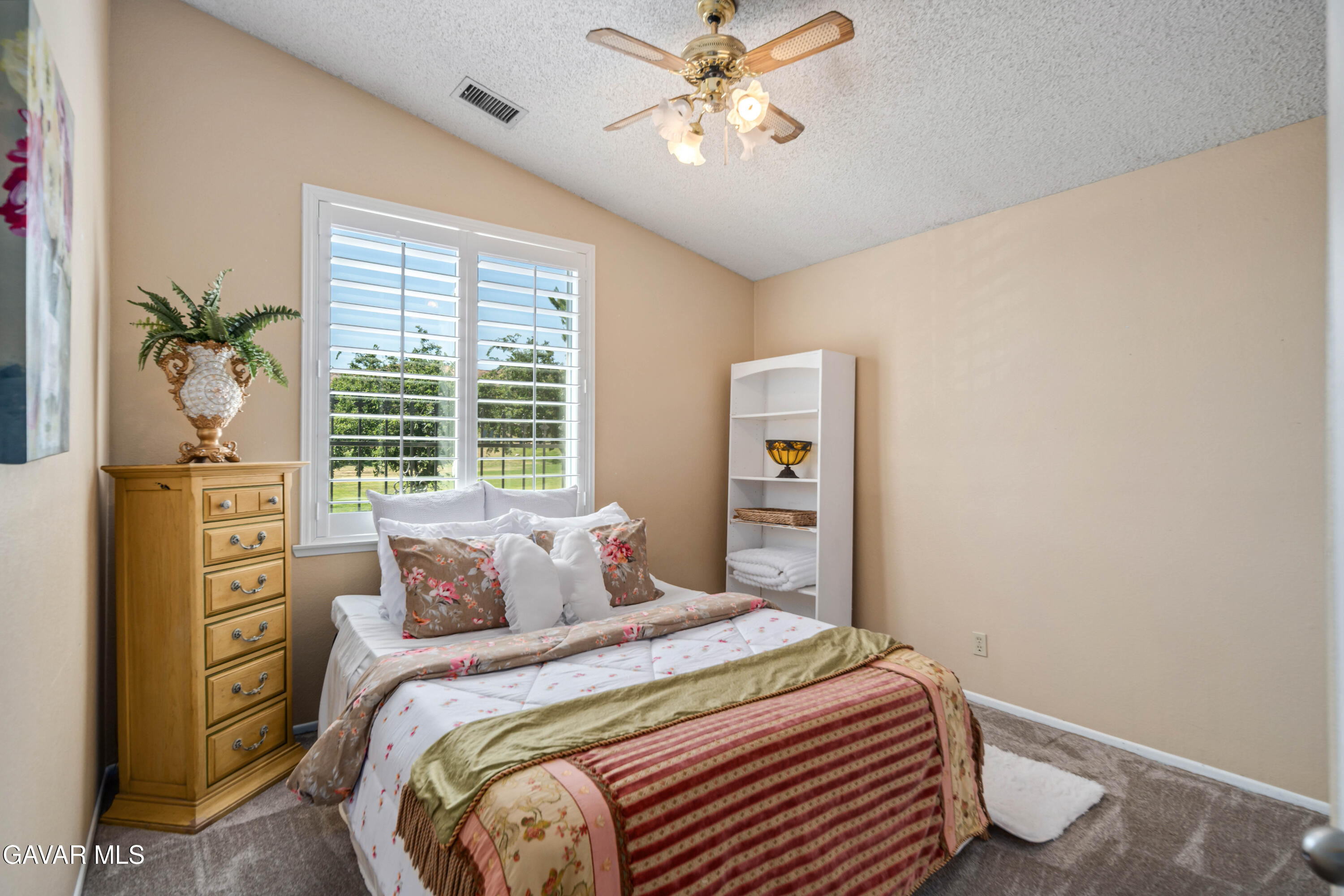 4535 Talento Way Palmdale, CA 93551 - Photo 28 of 43 a bedroom with a bed and a chandelier